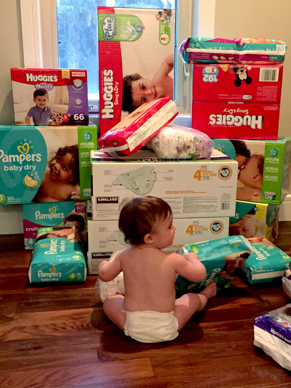 Baby sitting in front of diaper donations