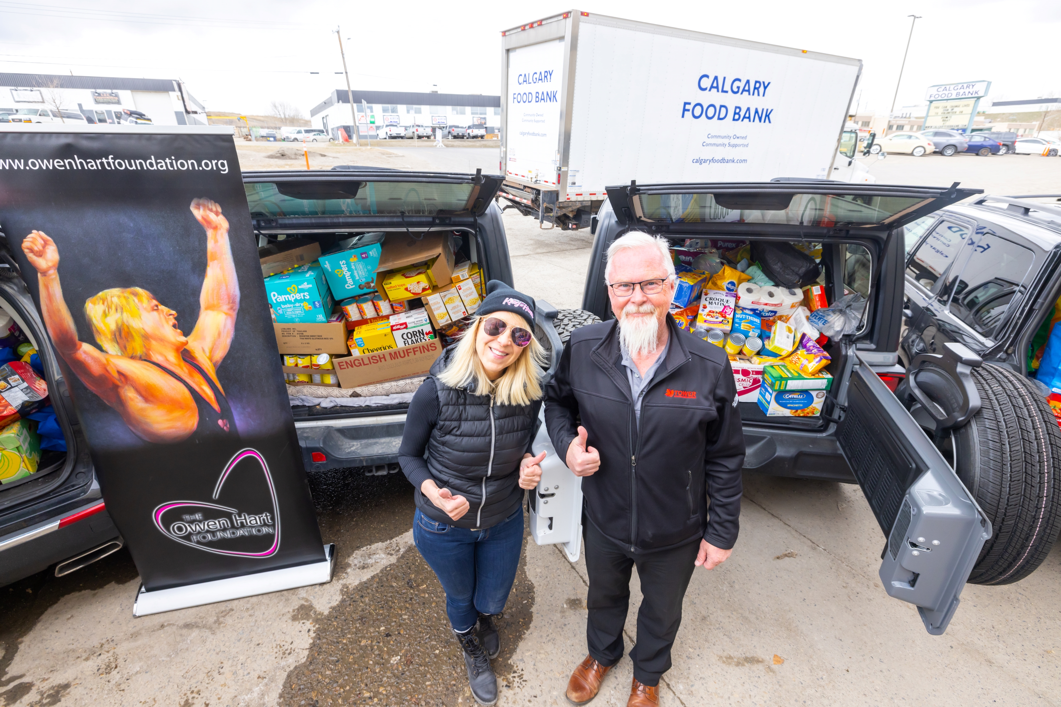 The Owen Hart Foundation food donation with four cars filled with food